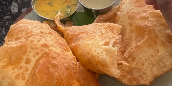 A dish photographed on a phone at a cafe table